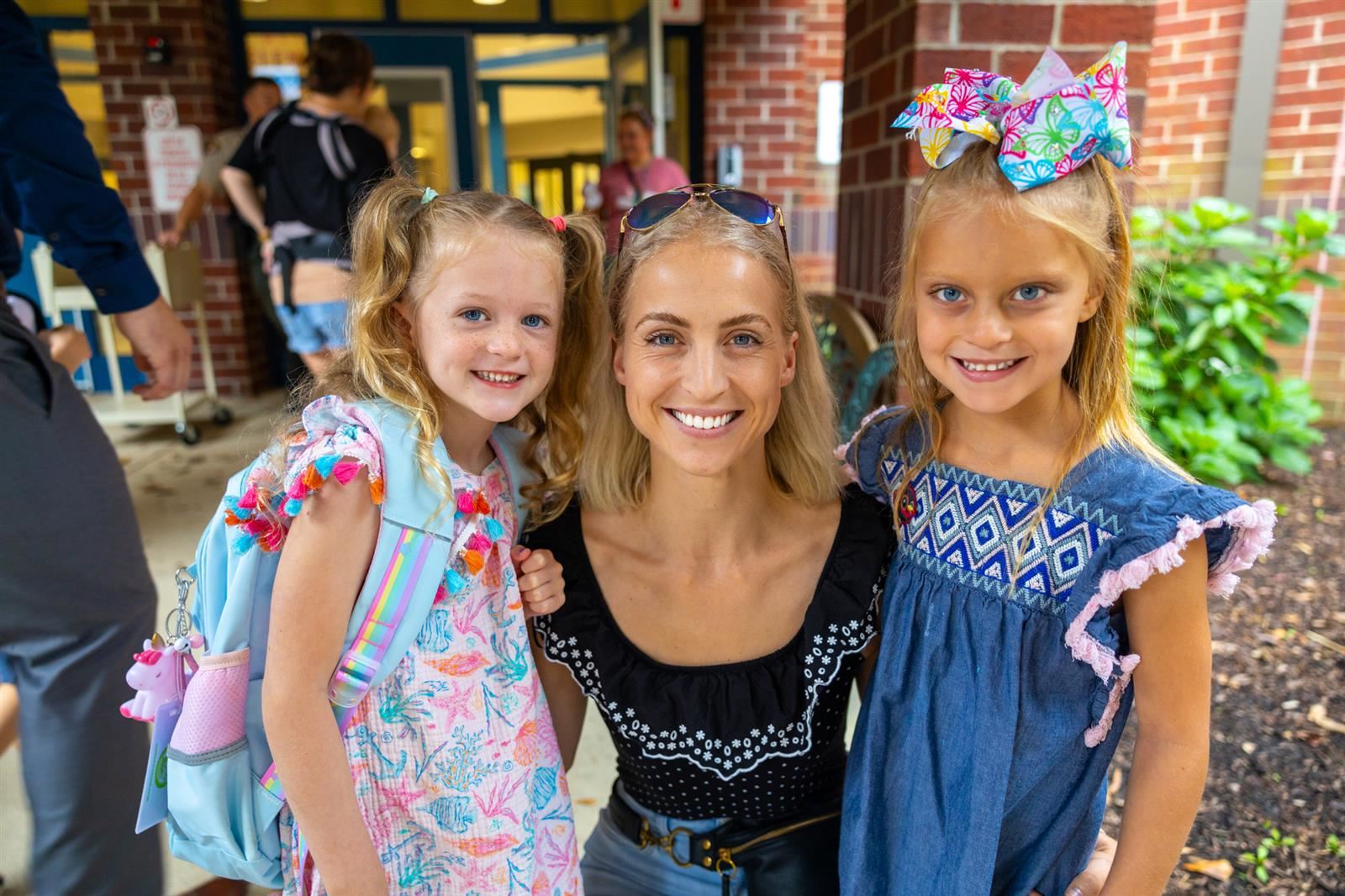 mom and two daugthers smiling